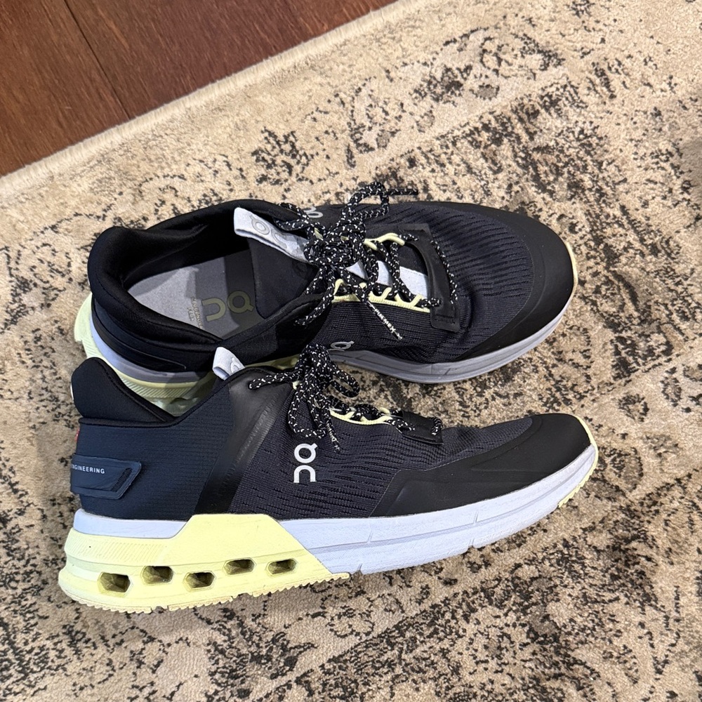 On Running Black Sneakers with Pale Yellow Heel Accents